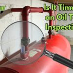 an oil tank in a basement in a Bucks County, PA home overlaid with a magnifying glass, representing an inspection
