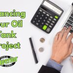 a close-up of hands using a computer and a calculator to learn more about financing their oil tank project in Bucks County, PA