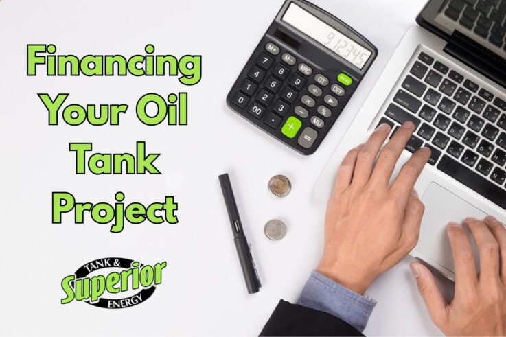 a close-up of hands using a computer and a calculator to learn more about financing their oil tank project in Bucks County, PA